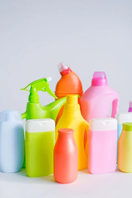 why-choose-us A woman in a protective suit sanitizes an indoor area using fogging equipment.